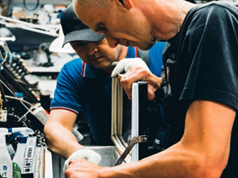 padre-e-figlio-al-lavoro-nella-loro-officina-artigiana-1grpe